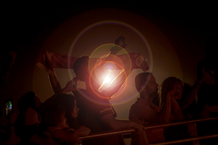 Hooligans in backlight celebrating football team in the night