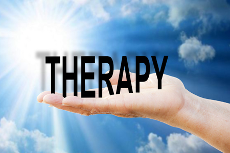 Hand is holding the write "THERAPY"の写真素材