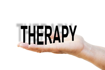 Hand is holding the write "THERAPY"の写真素材