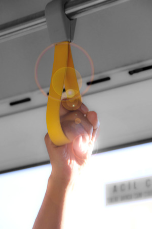 Holding the handle while traveling on the busの写真素材