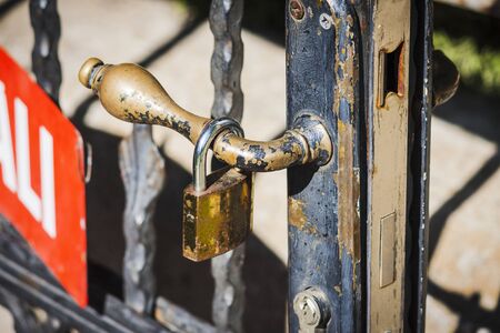 Lock hanged on the handle of a gate