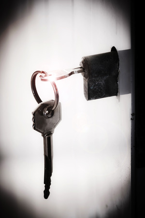 The key is inserted in the lock of a doorの写真素材
