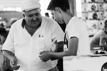 Turkish man is paying a boyのeditorial素材