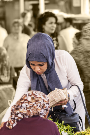 Turkish woman is paying at bazaarのeditorial素材