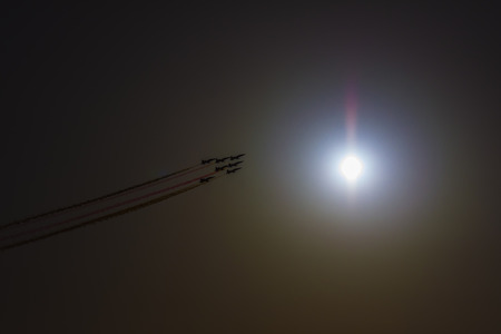 Turkish acrobatic aviation squadron flying over Izmir (Turkey). Backlit image against the sun