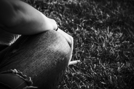 Smoking on the grass - Black and whiteの写真素材
