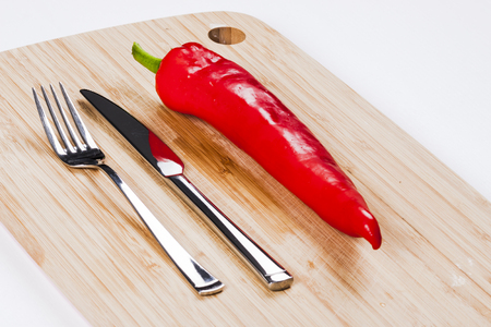 Red pepper on chopping boardの写真素材