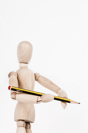 Wooden puppet holding painting brushの写真素材