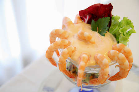 In this photo we have a cup of cocktail of shrimps, with cocktail sauce.の写真素材
