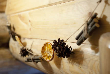 cones sticks and lemon skewered on rope on logsの写真素材