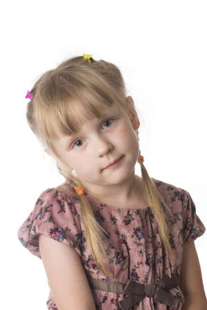 little serious girl in brown dress on white isolated backgroundの写真素材