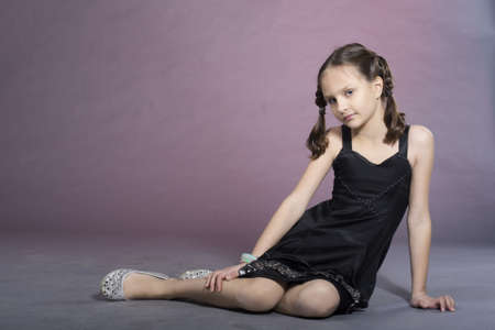 Little preteen nice smiling girl posing in studioの写真素材
