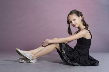Little preteen nice smiling girl posing in studioの写真素材