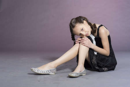 Little preteen nice smiling girl posing in studioの写真素材