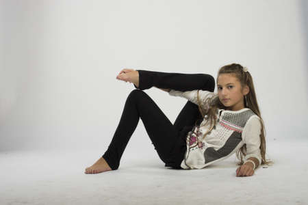 Cute teenage girl smiling and dancing in studioの写真素材