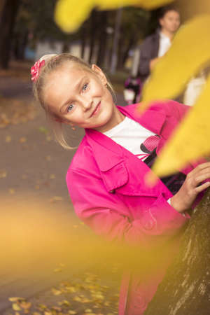 Little preteen girl playing outdoor in park at autumnの写真素材