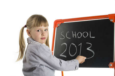 Little girl writing school 2013 at blackboardの写真素材