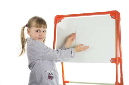 Nice happy smiling girl showing drawing at whiteboardの写真素材