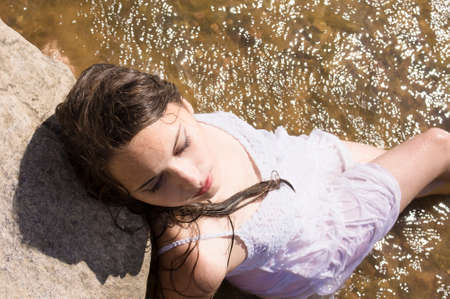 teen mernaid  Girl in white wet dress Outdoors in the lakeの写真素材