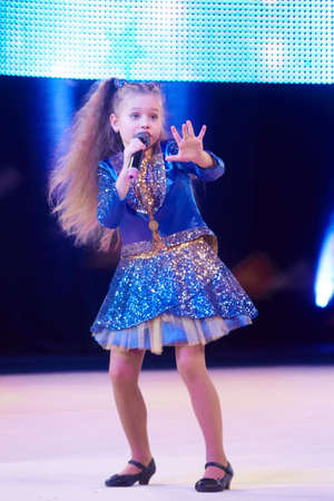 MINSK, BELARUS DECEMBER 05: Sofia Bogdanova sing a song during 'Baby Cup - BSB Bank' children's competitions in gymnastics , 05 December 2015 in Minsk, Belarus.のeditorial素材