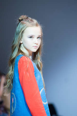 MINSK-NOVEMBER 7: An unidentified girl wears dress collection at the international exhibition of the fashion, Kids fashion day during Belarus Fashion Week on November 7, 2018 in Minsk, Belarus.のeditorial素材