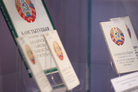 The image shows two important legal texts side by side - the Constitution of the Republic of Belarus...