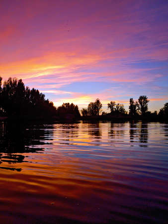 This photo was shot at sunset, in the summer, on Tormes River, in Salamanca, Spain. It has clean, beautiful tones of purple, orange and peaks of the blue sky. It can be used as a background if cut. It gives a peaceful, serene feeling.の写真素材
