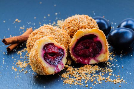 Plum dumplings. Traditional homemade sweet plum dumplings with crumble and cinnamon.の写真素材