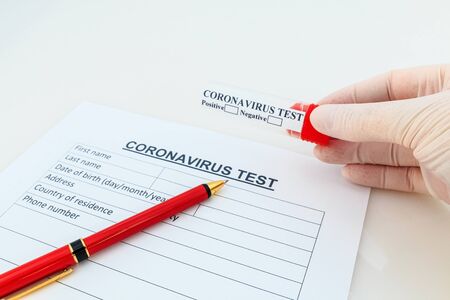 Coronavirus blood test concept. Doctor hand in medical glove holding test tube.の写真素材