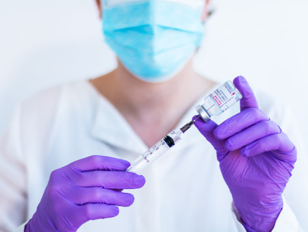 Brasov, Romania - February 21, 2021: Doctor using Moderna Covid-19 vaccine on a white background.のeditorial素材