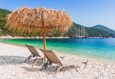 Kefalonia, Greece. Beach chair and umbrella at the Antisamos beach.の写真素材
