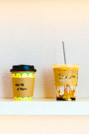An illustrative editorial of the Maxx Coffee Cappuccino and Iced Coffee with caramel and a stainless...