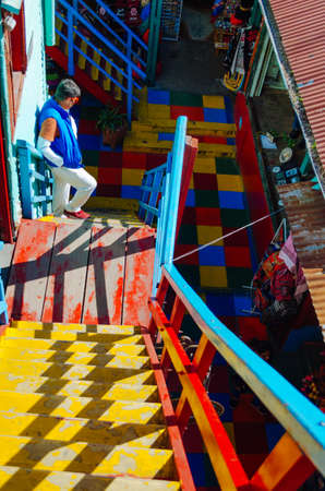 Buenos Aires, Argentina - September 05, 2018: The famous colours of El Caminito and a guy matching...