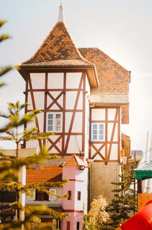 Side view of a shop display with red walls shaped as a lovely red colonial house in Vila GermÃ¢nica, Blumenau - Brazil during the afternoon.のeditorial素材