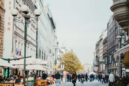 Prague, Czechia - A woman using winter clothes and looking to the side in a crowded square full of tourists and locals.のeditorial素材