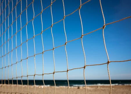 Closeup of beach volleyball net at sunsetの写真素材
