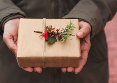 Woman holding homemade wrapped Christmas Presentの写真素材