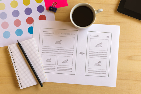 Designer desk with wireframe sketches for responsive website. Flat layの写真素材