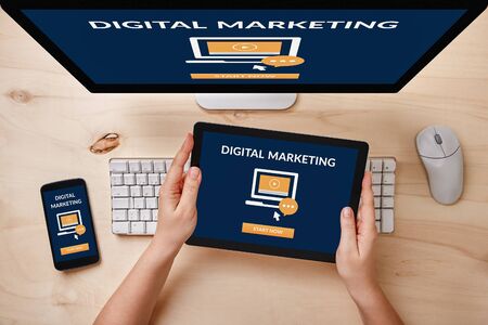 Digital marketing concept on computer, tablet and smartphone screen over wooden table. Top view of responsive devices.の写真素材