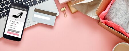 Online store for women on smart phone screen over pink copy space web banner background. Top viewの写真素材