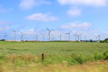 Wind generators from car windows along the roadの写真素材