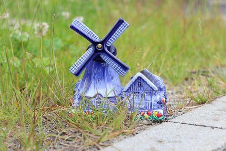 Porcelain windmill with a barn beside the roadの写真素材