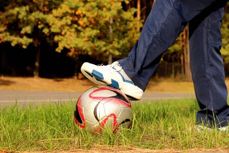 teen with soccer ball on stadiumの写真素材