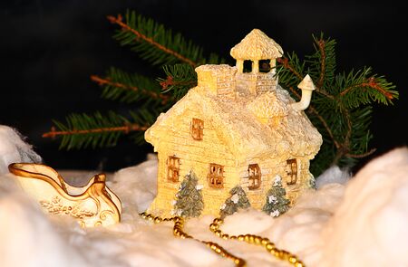 Christmas house and sleigh in the snow.の写真素材