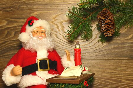 Santa Claus sitting at the table with candlesの写真素材