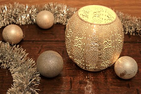 still life of Christmas tinsel, balls and bowls with candlesの写真素材