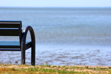 Bench to relax on the beach in the low tideの写真素材