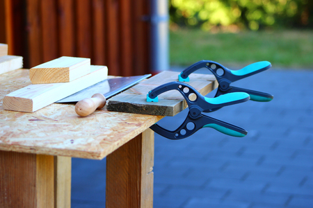 manual clamp and handsaw carpenter tool on the workbenchの写真素材