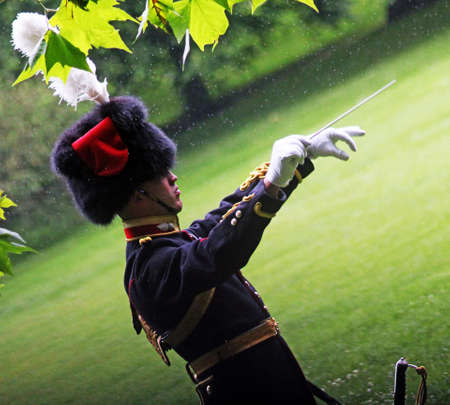 Director of Music conducting in the rain London england