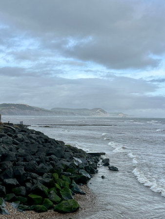A view of the coast in in Lyme Regis Dorset England on a cloudy day.の写真素材